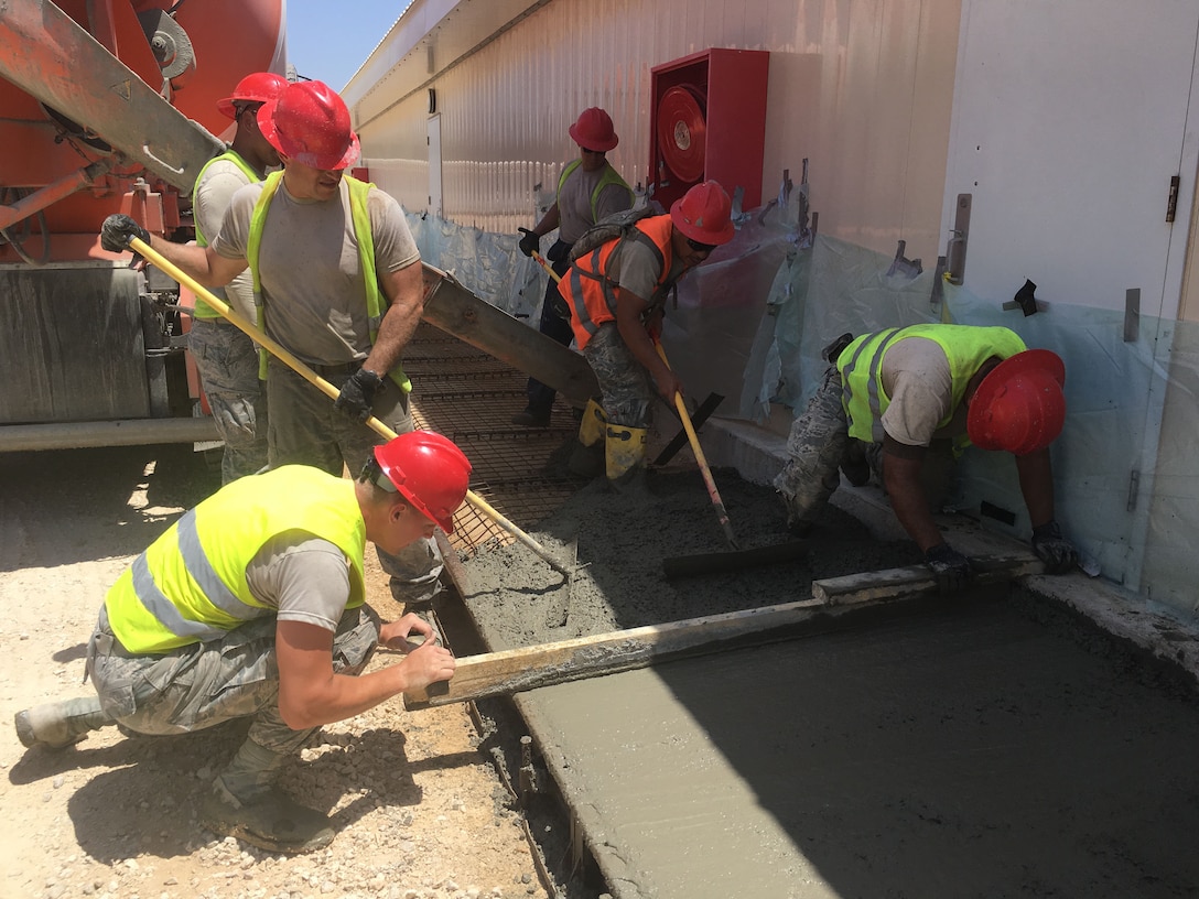 Members of the 219th RED HORSE Squadron of the Montana Air National Guard finish a concrete sidewalk on an Israeli Defense Force base. (U.S. Air National Guard photo)