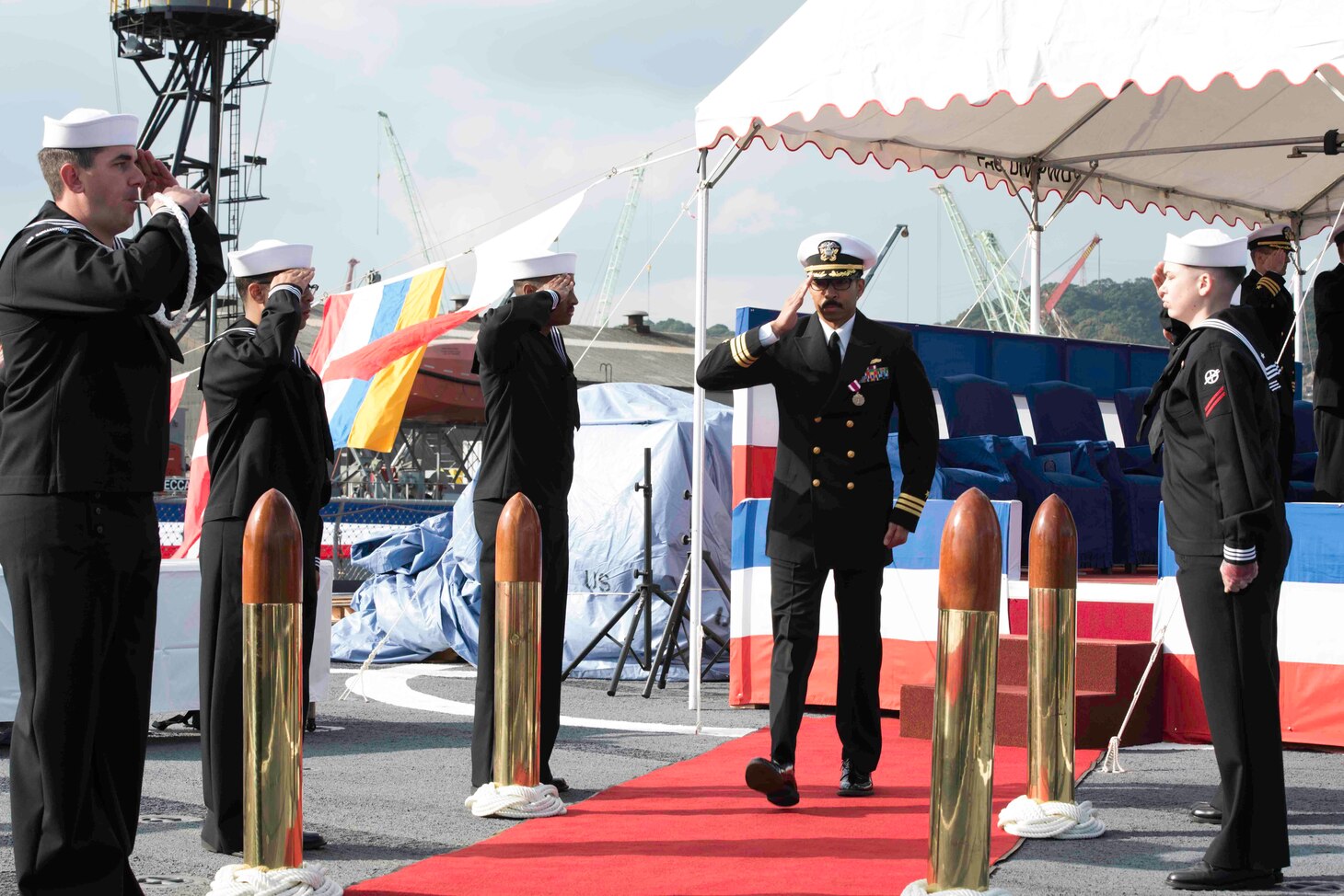 Cmdr. Severn Stevens salutes the side boys at the conclusion of a change of command ceremony aboard the amphibious dock landing ship USS Germantown (LSD 42). Cmdr. Jimmie Jensen relieved Stevens as commanding officer of Germantown.