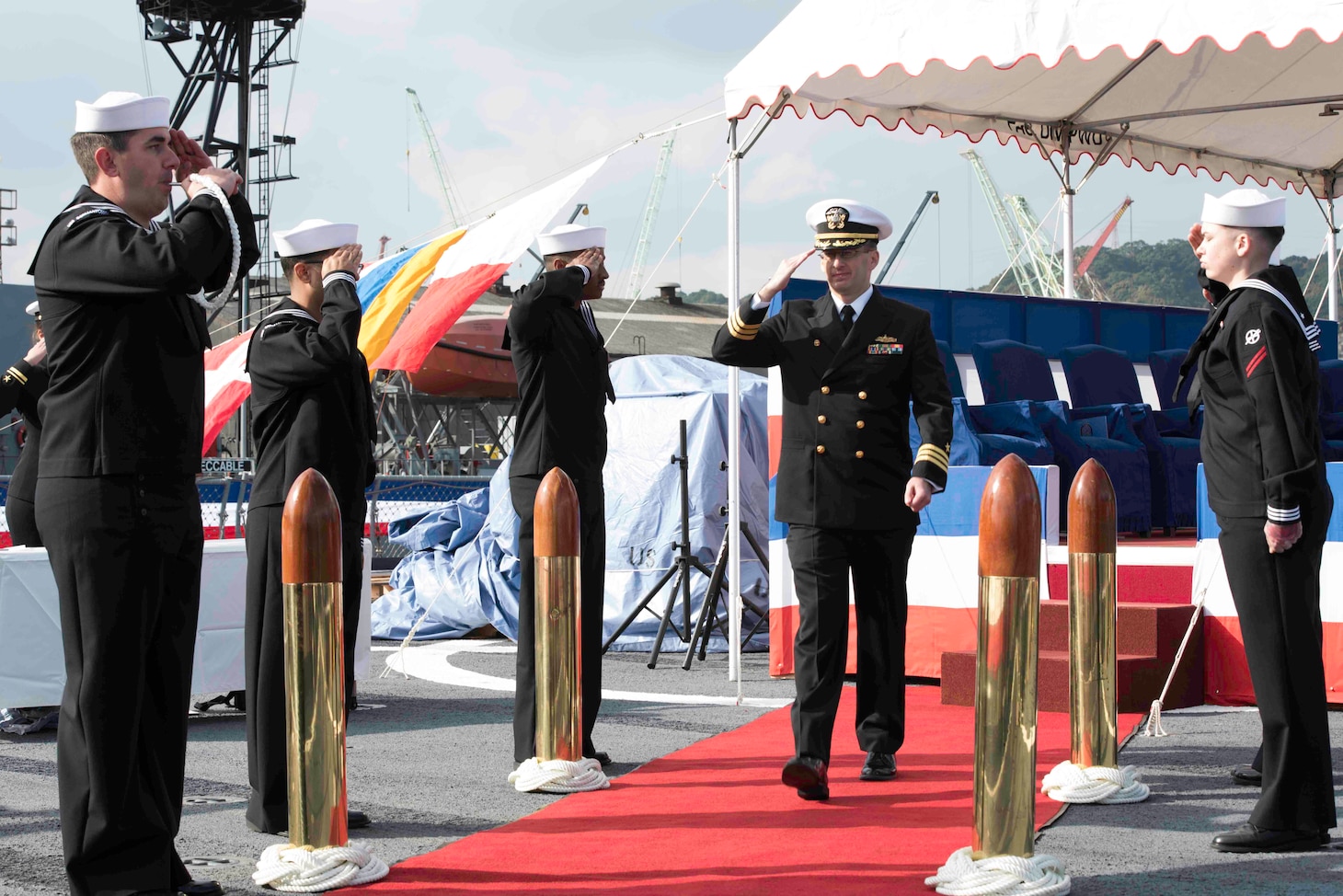 Cmdr. Jimmie Jensen salutes the side boys at the conclusion of a change of command ceremony aboard the amphibious dock landing ship USS Germantown (LSD 42). Jensen relieved Cmdr. Severn Stevens as commanding officer of Germantown.