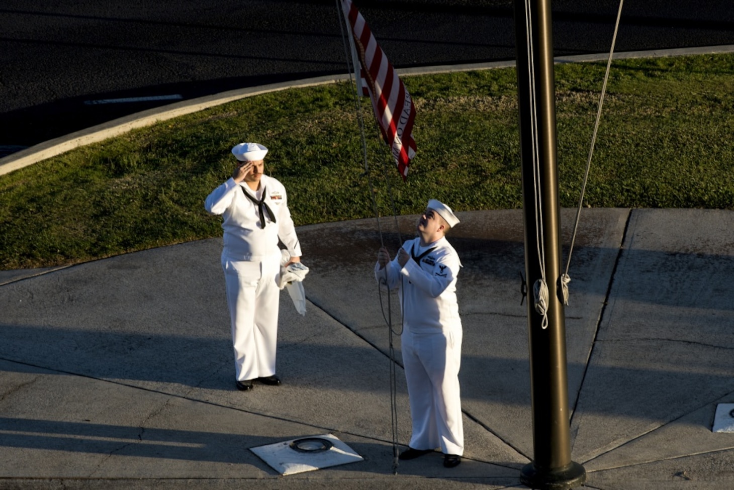 Culinary Specialist 2nd Class Gerado Taddei and Yeoman 2nd Class Andrew Thompson fly the "First Navy Jack" to start the New Year on Joint Base Pearl Harbor-Hickam. Rear Adm. Brian Fort, commander, Navy Region Hawaii and Naval Surface Group Middle Pacific, directed the base headquarters building to fly the "First Navy Jack" throughout 2018 to honor the 17 shipmates we lost on USS Fitzgerald (DDG-62) and USS John S. McCain (DDG-56) and as a reminder that our warfighting edge is not only back but renewed and forged with purpose.
