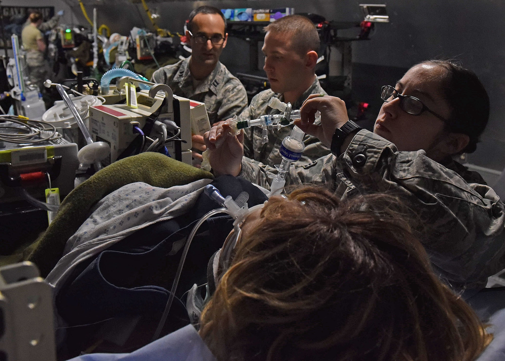 U.S. Air Force Capt. Andrew Hersh, Critical Care Air Transport physician from Joint Base San Antonio, Texas; U.S. Air Force Capt. Matthew Thompson, CCAT nurse from Keesler Air Force Base, Biloxi, Miss.; and Senior Airman Alysia Bator, CCAT respiratory therapist from Westover Air Reserve Base, Chicopee, Mass., test their clinical skills during the two-week CCAT Initial Course inside the USAFSAM lab at Wright-Patterson Air Force Base, Ohio, Dec. 8, 2017. (U.S. Air Force photo by Michelle Gigante)