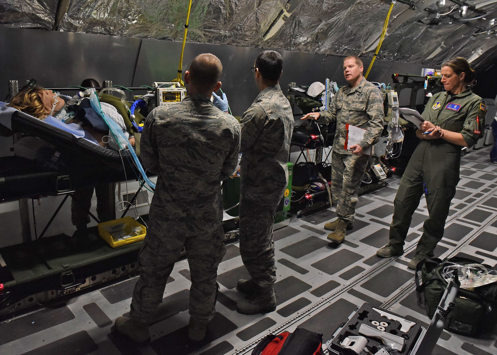 U.S. Air Force Lt. Col. Greg Malone, Critical Care Air Transport medical director at the U.S. Air Force School of Aerospace Medicine, 711th Human Performance Wing, speaks to a CCAT team after evaluating their clinical skills during CCAT training inside the USAFSAM lab at Wright-Patterson Air Force Base, Ohio, Dec. 8, 2017. The students were being evaluated on preparing a simulated patient for flight. (U.S. Air Force photo by Michelle Gigante)