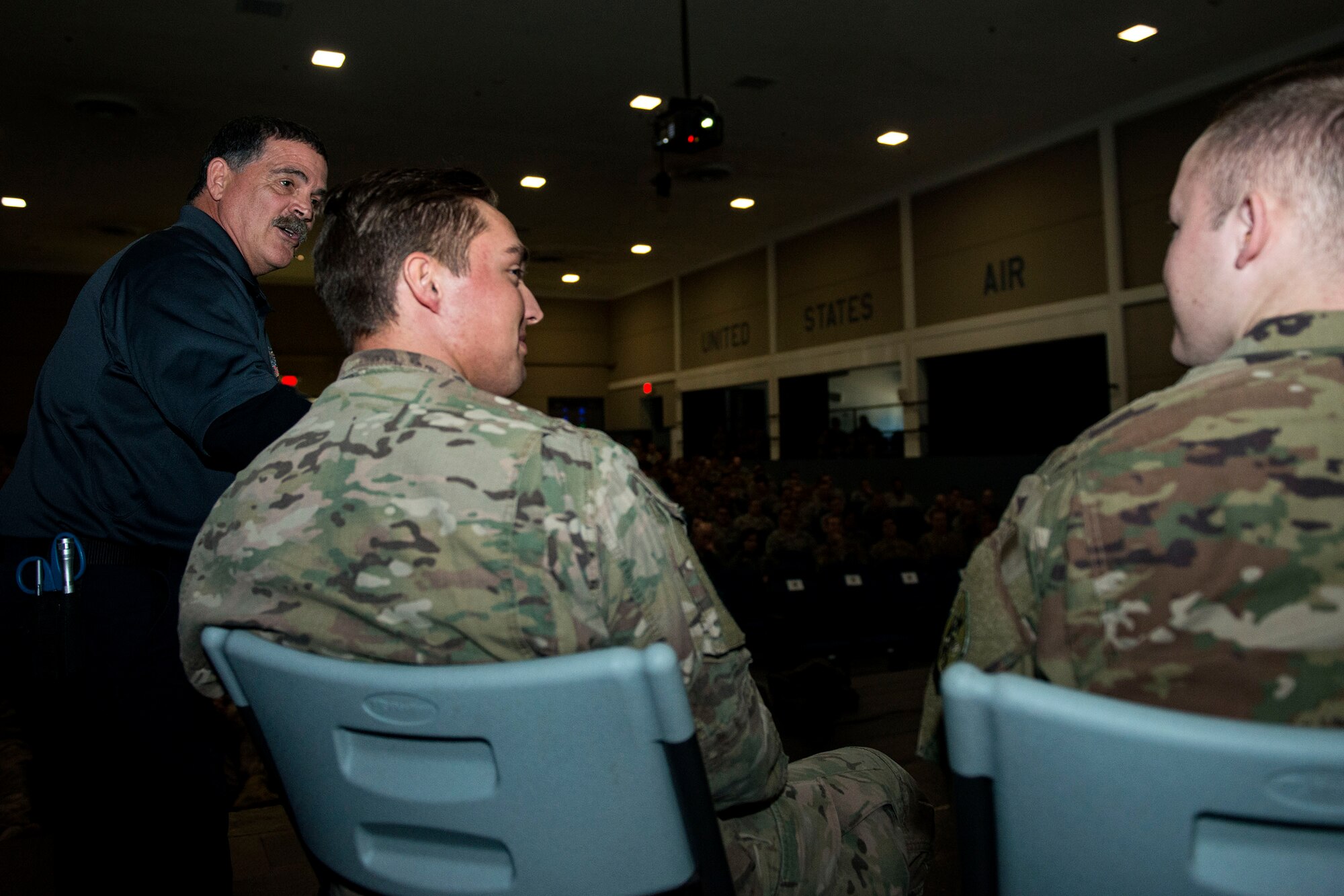 Ronny Garcia, left, safety training coordinator, discusses driving safety with Senior Airman Cody Stoltenburg, middle, 71st Rescue Squadron intelligence analyst, and Airman 1st Class Tyler Amrine, 347th Operation Support Squadron intelligence analyst, during a Street Smart presentation, Jan. 2, 2018, at Moody Air Force Base, Ga. The presenters utilized Airmen to simulate the potential results of drunk driving. Street Smart is a safety program designed to emphasize the dangers of making poor decisions and then driving a vehicle. (U.S. Air Force photo by Airman 1st Class Erick Requadt)