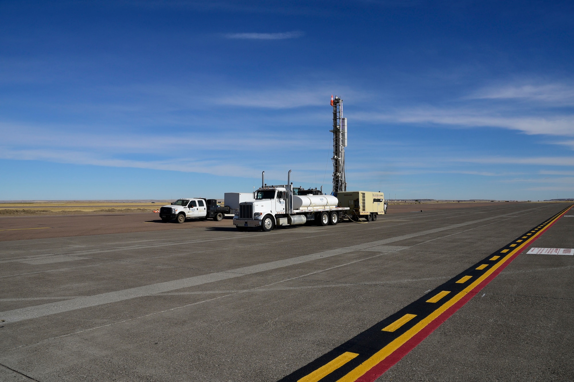 Contract environmental well drillers drill a water well on the ramp of the 120th Airlift Wing in Great Falls, Mont. Sept. 21, 2017. The wells will be tested and monitored for contaminants as part of the ongoing Installation Restoration Program on the Montana Air National Guard base. (U.S. Air National Guard photo/Senior Master Sgt. Eric Peterson)