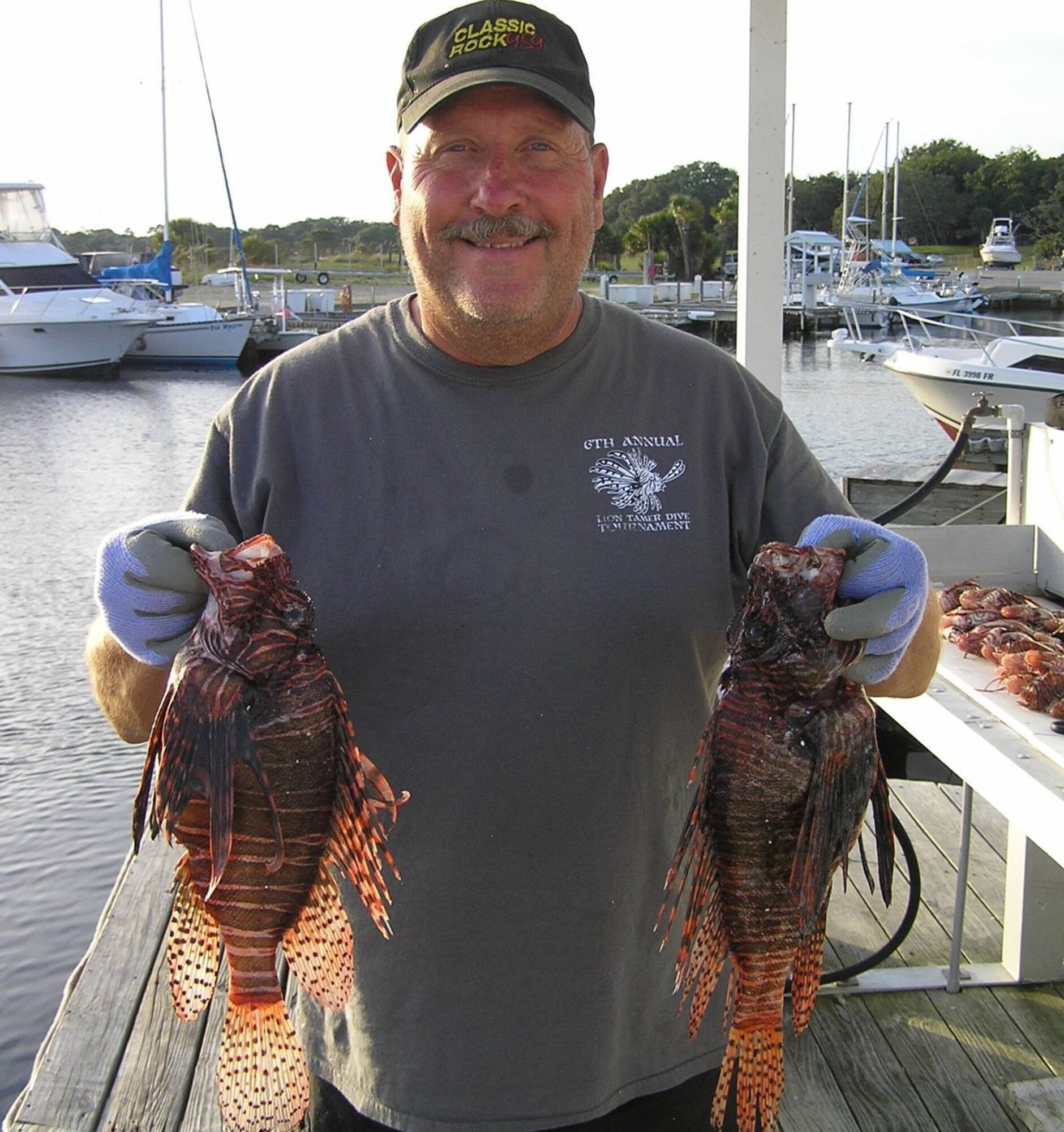 Man holding lionfish.