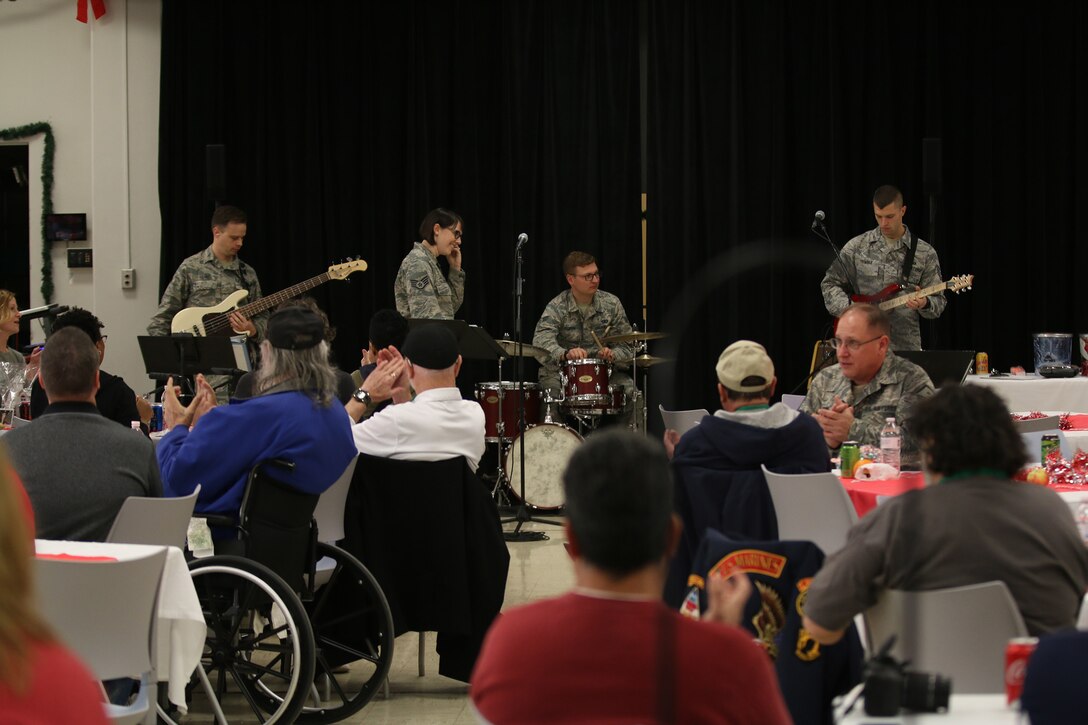 Area veterans and Airmen listen to a holiday performance by members of the Air Force Band of Flight during the Dayton Veterans Affairs Medical Center complex Christmas party luncheon December 2, 2017