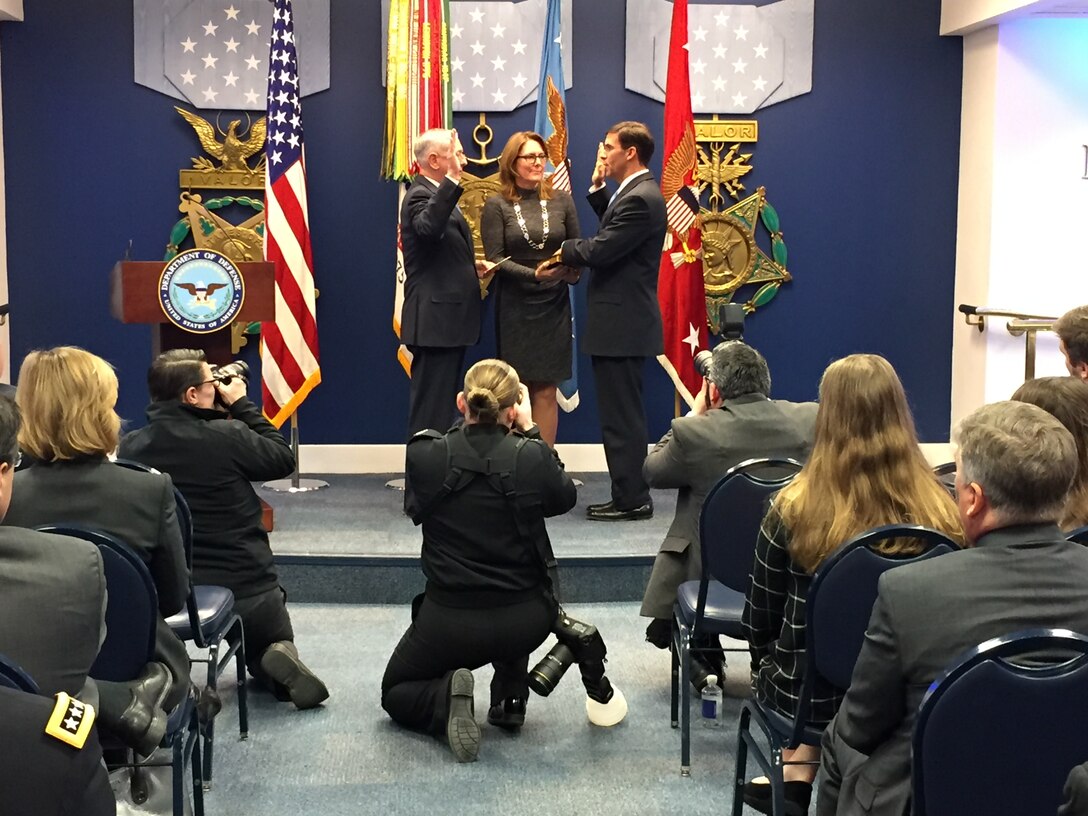 Defense Secretary James N. Mattis, left, administers a ceremonial oath of office to Army Secretary Mark T. Esper at the Pentagon’s Hall of Heroes, Jan. 5, 2018. Esper’s wife, Leah, holds the Bible.