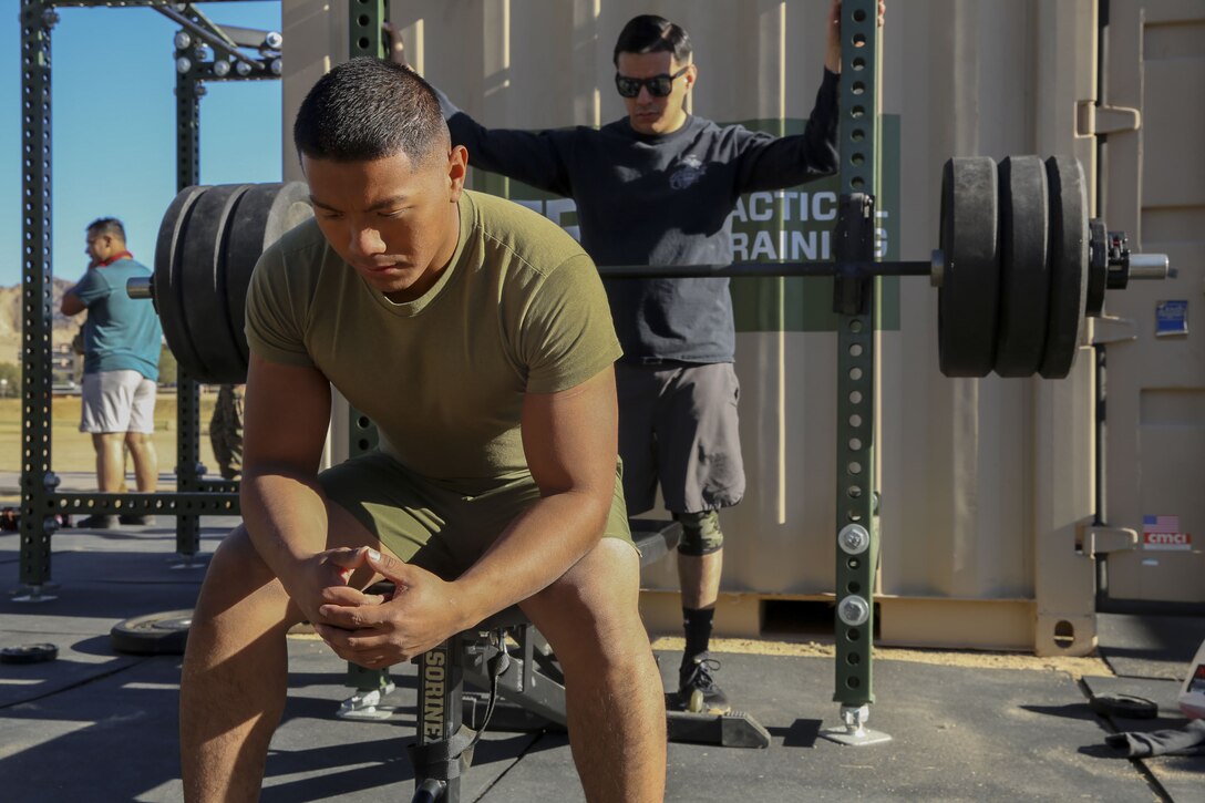 Cpl. Raul Ebanies, embark, Marine Wing Support Squadron 374, prepares his mind to reach a new personal record of 280-pounds during the Iron Rhino weightlifting competition at Del Valle High Intensity Tactical Training field aboard the Marine Corps Air Ground Combat Center, Twentynine Palms, Calif., Dec. 13, 2017. The Iron Rhino event was the first weightlifting competition hosted by MWSS-374 where competitors had three attempts to reach their maximum deadlift, bench, and squat, to claim the title of Iron Rhino. (U.S. Marine Corps photo by Cpl. Christian Lopez)