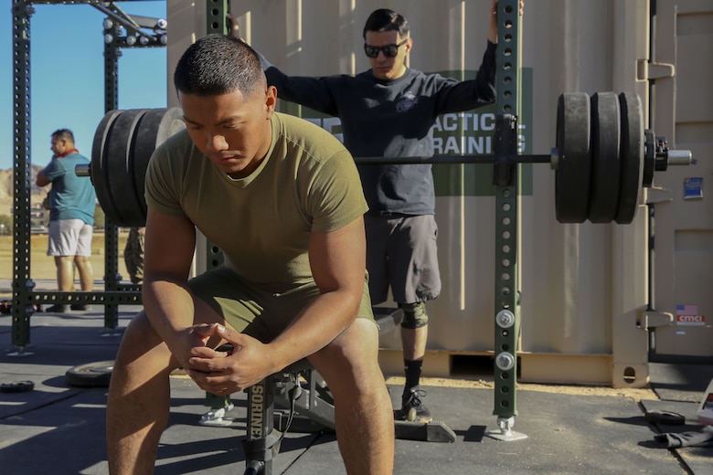 Cpl. Raul Ebanies, embark, Marine Wing Support Squadron 374, prepares his mind to reach a new personal record of 280-pounds during the Iron Rhino weightlifting competition at Del Valle High Intensity Tactical Training field aboard the Marine Corps Air Ground Combat Center, Twentynine Palms, Calif., Dec. 13, 2017. The Iron Rhino event was the first weightlifting competition hosted by MWSS-374 where competitors had three attempts to reach their maximum deadlift, bench, and squat, to claim the title of Iron Rhino. (U.S. Marine Corps photo by Cpl. Christian Lopez)