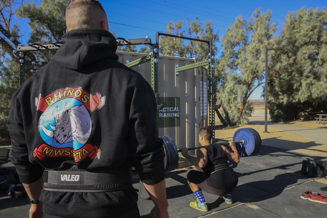 Lt. Col. Christopher Siler, commanding officer, Marine Wing Support Squadron 374, observes his executive officer perform a 370-pound squat during the Iron Rhino weightlifting competition at Del Valle High Intensity Tactical Training field aboard the Marine Corps Air Ground Combat Center, Twentynine Palms, Calif., Dec. 13, 2017. The Iron Rhino event was the first weightlifting competition hosted by MWSS-374 where competitors had three attempts to reach their maximum deadlift, bench, and squat, to claim the title of Iron Rhino. (U.S. Marine Corps photo by Cpl. Christian Lopez)