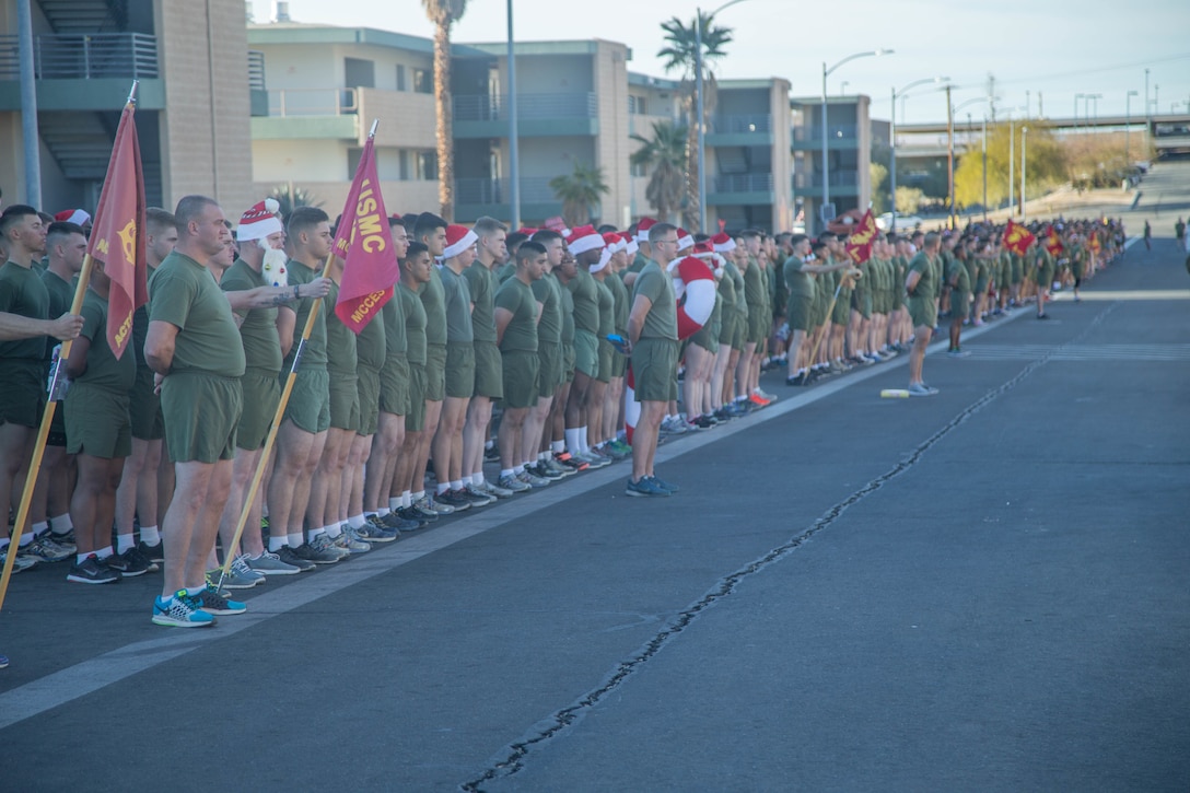 Marines with the Marine Corps Communication-Electronics School stand in formation prior to the annual Toys-for-Tots Run aboard the Marine Corps Air Ground Combat Center, Twentynine Palms, Calif., Dec. 18, 2017. Marines ran with toys and dropped them off in front of the Commanding General’s building. (U.S. Marine Corps photo by Lance Cpl. Preston L. Morris)