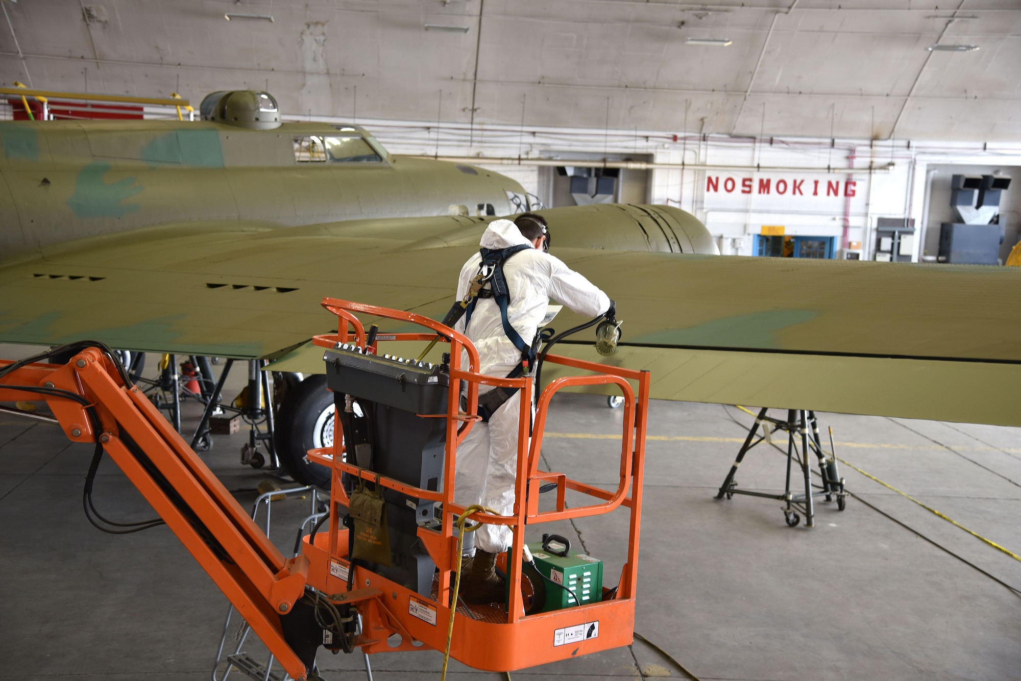 DAYTON, Ohio (12/28/2017) -- National Museum of the U.S. Air Force restoration specialist Casey Simmons paints the flight control surfaces on the Boeing B-17F Memphis Belle™. Plans call for the aircraft to be placed on permanent public display in the WWII Gallery here at the National Museum of the U.S. Air Force on May 17, 2018. (U.S. Air Force photo by Ken LaRock)