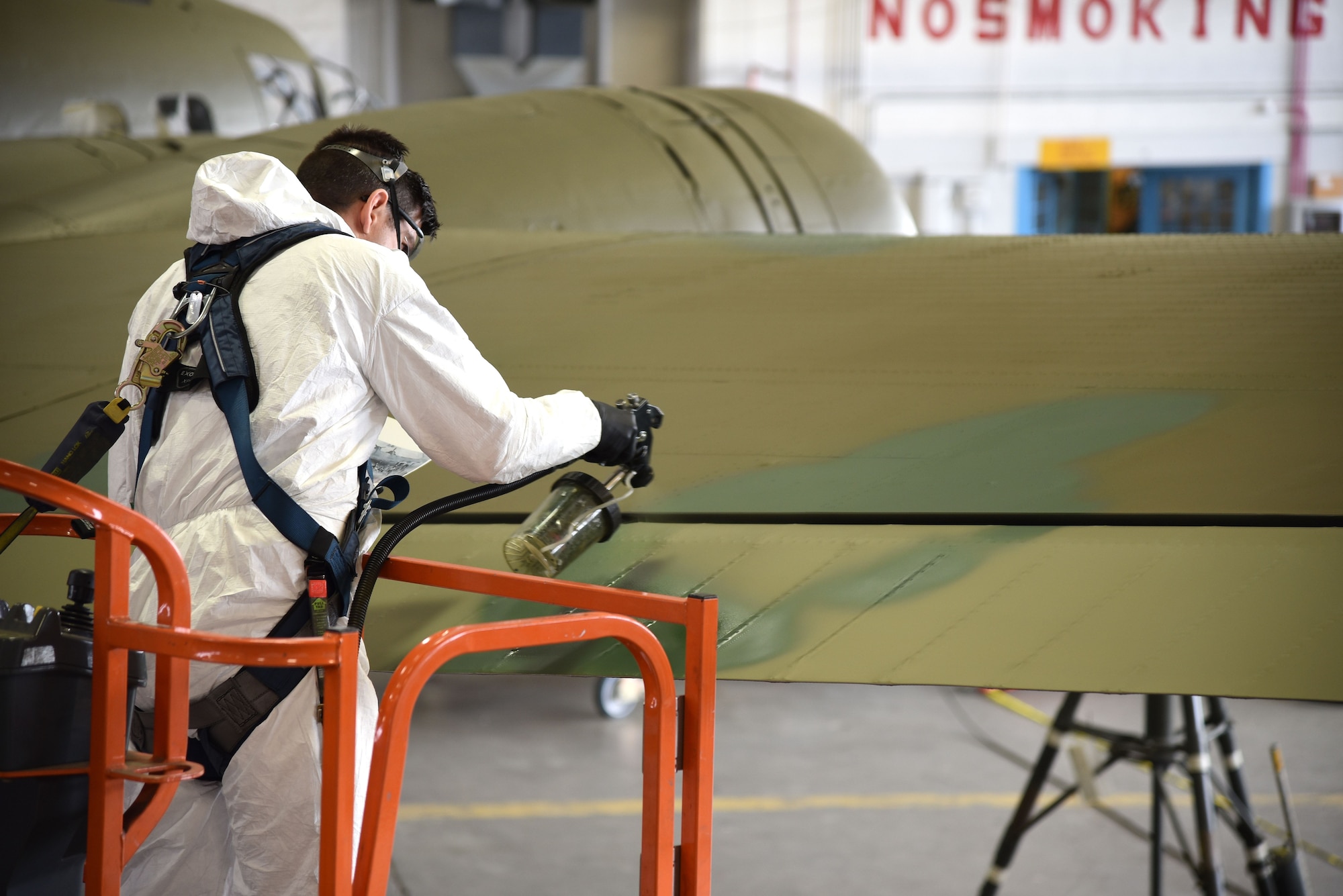 DAYTON, Ohio (12/28/2017) -- National Museum of the U.S. Air Force restoration specialist Casey Simmons paints the control surfaces on the Boeing B-17F Memphis Belle™. Plans call for the aircraft to be placed on permanent public display in the WWII Gallery here at the National Museum of the U.S. Air Force on May 17, 2018. (U.S. Air Force photo by Ken LaRock)