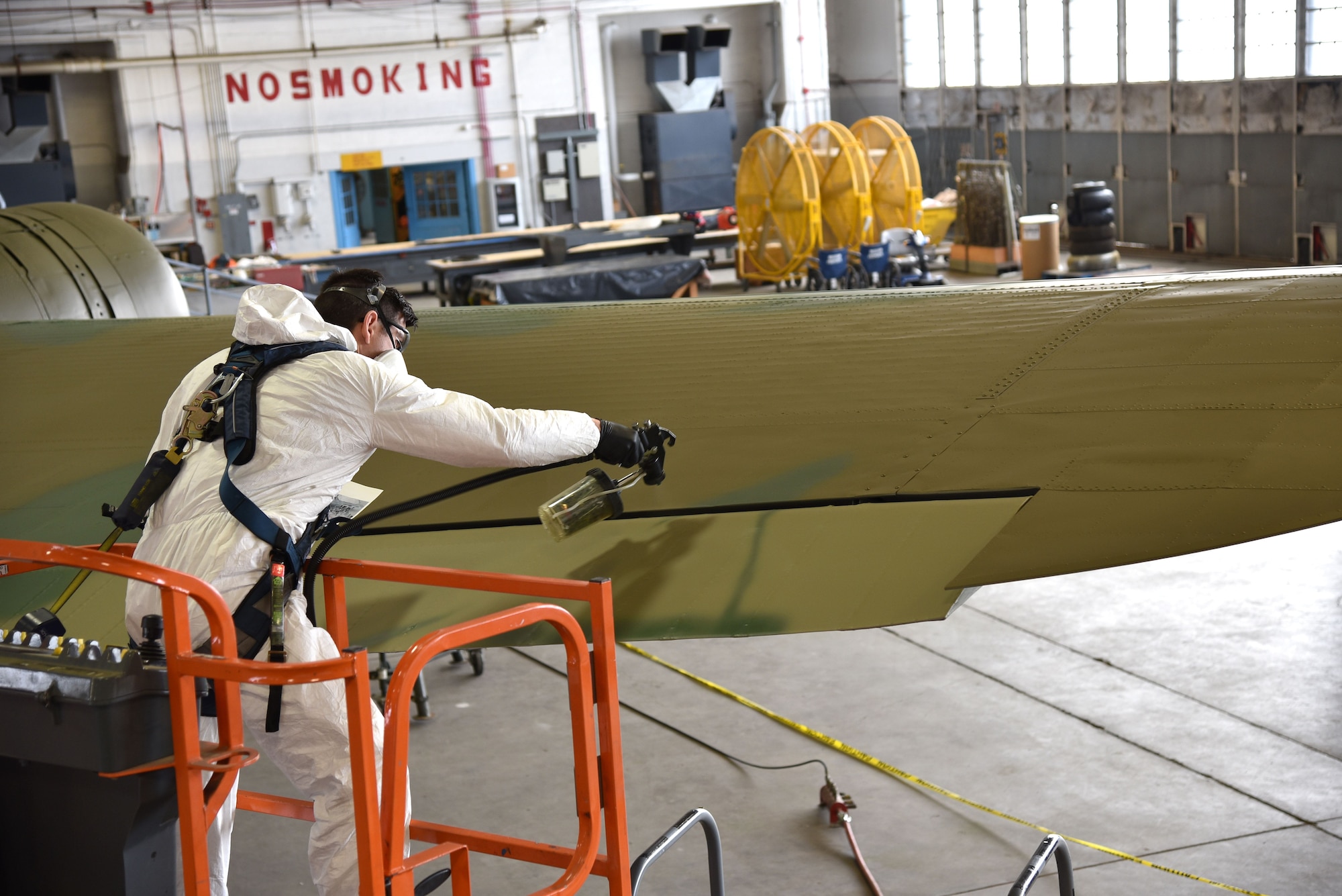 DAYTON, Ohio (12/28/2017) -- National Museum of the U.S. Air Force restoration specialist Casey Simmons paints the control surfaces on the Boeing B-17F Memphis Belle™. Plans call for the aircraft to be placed on permanent public display in the WWII Gallery here at the National Museum of the U.S. Air Force on May 17, 2018. (U.S. Air Force photo by Ken LaRock)