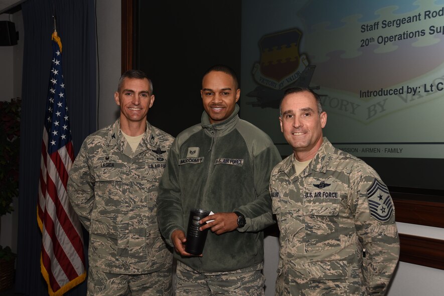 U.S. Air Force Staff Sgt. Roderick McCorvey, 20th Operations Support Squadron (OSS) commander’s support staff (CSS) personnel specialist, middle, is recognized by Col. Daniel Lasica, 20th Fighter Wing (FW) commander, left, and Chief Master Sgt. Daniel Hoglund, 20th FW command chief, at Shaw Air Force Base, S.C., Jan. 3, 2018.