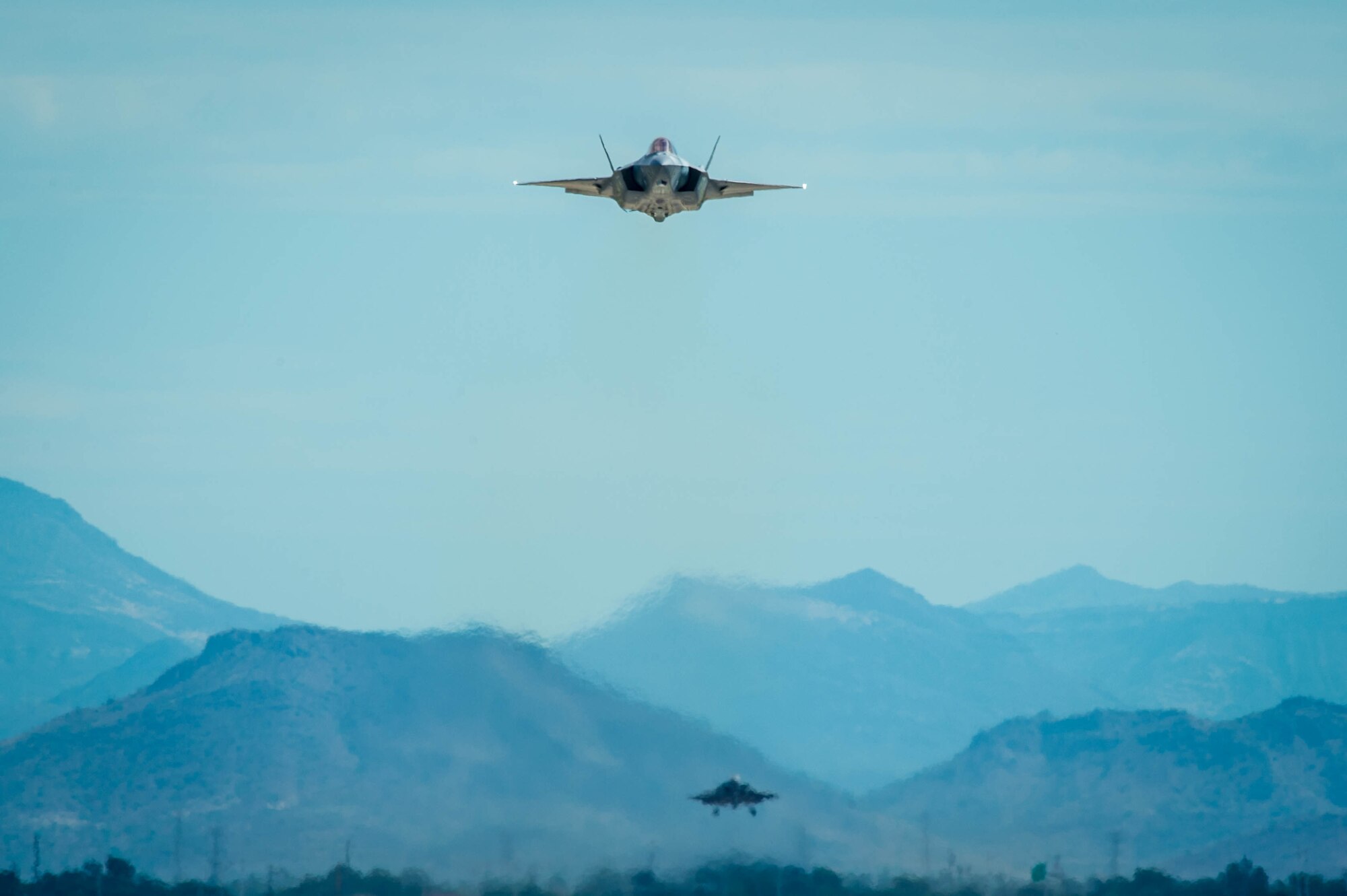 An F-35A Lightning II flies over the flightline at Luke Air Force Base, Ariz. Aug. 21, 2017. The F-35 is a multirole fighter jet able to perform missions which traditionally required numerous specialized aircraft. As the primary training location for the U.S. Air Force and partner nations, Luke is currently home to 61 F-35s projected to grow to 144 in the near future. (U.S. Air Force photo/Staff Sgt. Jensen Stidham)