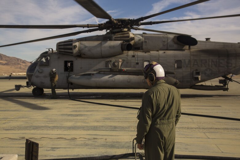 U.S. Marine Corps Cpl. Brandon Martsold, the line safety noncommissioned officer assigned to Marine Wing Support Squadron 374, ensures safety as a CH-53E Super Stallion, assigned to Marine Heavy Helicopter Squadron (HMH) 465, refuels at Marine Corps Air Ground Combat Center Twenty-nine Palms, Calif., Dec. 9, 2017. Exercise Winter Fury allows Marines to exercise the skills needed as the combat element of the Marine Air Ground Task Force during a combat deployment. (U.S. Marine Corps photo by Cpl. Isaac D. Martinez)
