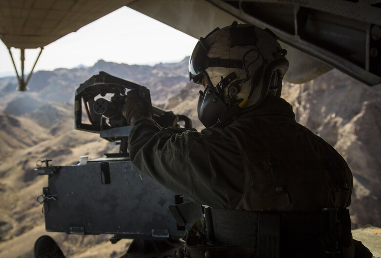U.S. Marine Corps Cpl. Mitchell McCartney, a crew member assigned to Marine Heavy Helicopter Squadron (HMH) 465, operates the M2 Browning heavy machine gun at the rear of the CH-53E Super Stallion as it flies above the Chocolate Mountain Aerial Gunnery Range, Dec. 9, 2017. HMH-465 arrived to MCAS Yuma, Nov. 29, 2017 to conduct training in support of Exercise Winter Fury. Exercise Winter Fury allows Marines to exercise the skills needed as the combat element of the Marine Air Ground Task Force during a combat deployment. (U.S. Marine Corps photo by Cpl. Isaac D. Martinez)