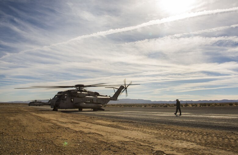 U.S. Marine Corps Cpl. Mitchell McCartney, a crew member assigned to Marine Heavy Helicopter Squadron (HMH) 465, walks toward a CH-53E Super Stallion as it sits on the flight line at Marine Corps Air Ground Combat Center Twenty-nine Palms, Calif., Dec. 9, 2017. HMH-465 arrived to MCAS Yuma, Nov. 29, 2017 to conduct training in support of Exercise Winter Fury. Exercise Winter Fury allows Marines to exercise the skills needed as the combat element of the Marine Air Ground Task Force during a combat deployment. (U.S. Marine Corps photo by Cpl. Isaac D. Martinez)