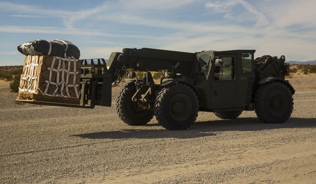 A U.S. Marine Corps Extended Boom Forklift (EBFL), moves supplies to a CH-53E Super Stallion, assigned to Marine Heavy Helicopter Squadron (HMH) 465, at Marine Corps Air Ground Combat Center Twenty-nine Palms, Calif.,  Dec. 9, 2017. HMH-465 arrived to MCAS Yuma, Nov. 29, 2017 to conduct training in support of Exercise Winter Fury. Exercise Winter Fury allows Marines to exercise the skills needed as the combat element of the Marine Air Ground Task Force during a combat deployment. (U.S. Marine Corps photo by Cpl. Isaac D. Martinez)