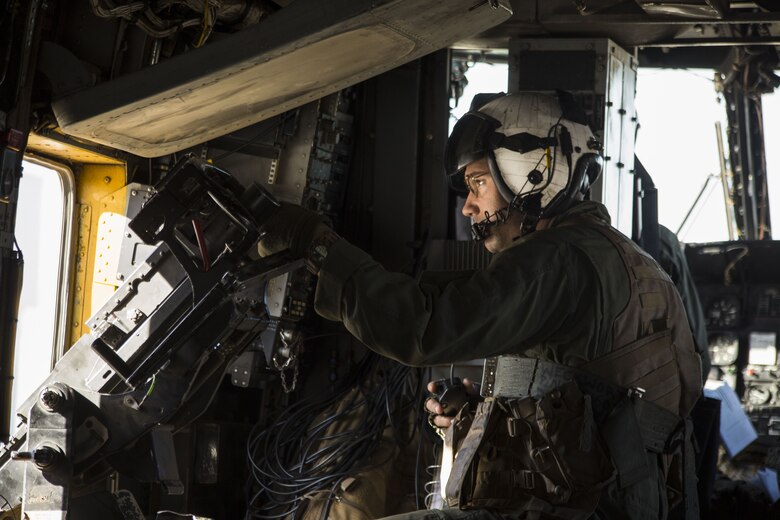 U.S. Marine Corps Lance Cpl. Kyle Missel, a crew chief assigned to Marine Heavy Helicopter Squadron (HMH) 465, observes the flight line as the CH-53E Super Stallion prepares to take off at Marine Corps Air Station (MCAS) Yuma, Ariz., Dec. 9, 2017. HMH-465 arrived to MCAS Yuma, Nov. 29, 2017 to conduct training in support of Exercise Winter Fury. Exercise Winter Fury allows Marines to exercise the skills needed as the combat element of the Marine Air Ground Task Force during a combat deployment. (U.S. Marine Corps photo by Cpl. Isaac D. Martinez)