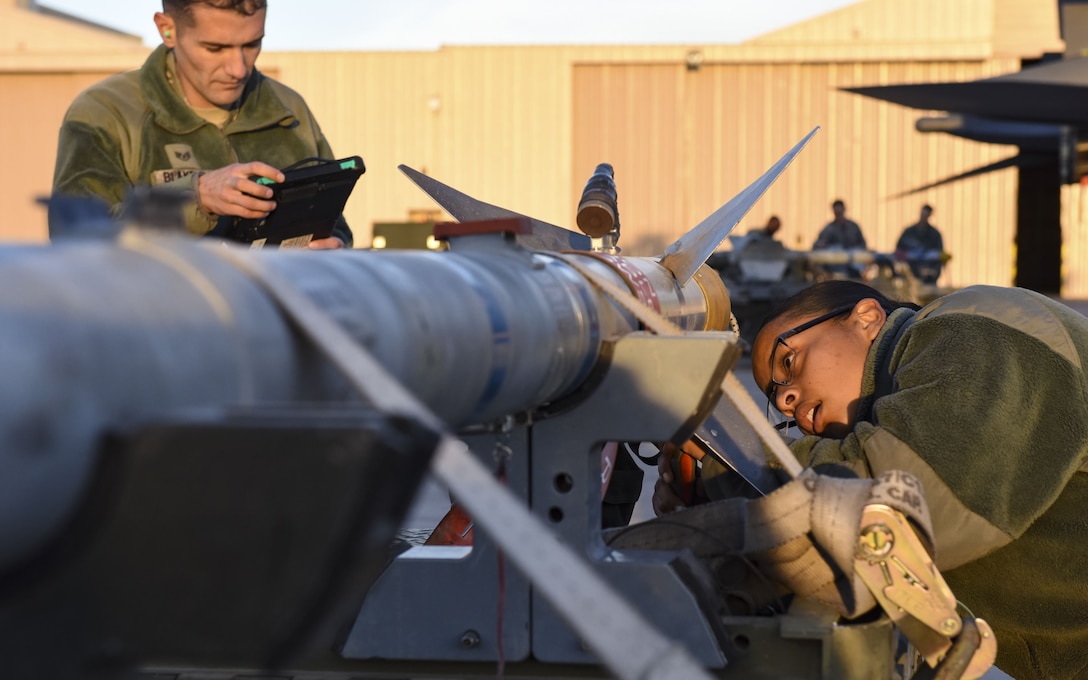 Airmen from the 57th Maintenance Group perform an inspection on an AIM-120 AMRAA during the quarterly load crew competition at Nellis Air Force Base, Nev., Jan. 5, 2018. The teams were evaluated on their speed and accuracy while loading munitions onto their aircraft. (U.S. Air Force photo by Airman 1st Class Andrew D. Sarver/Released)