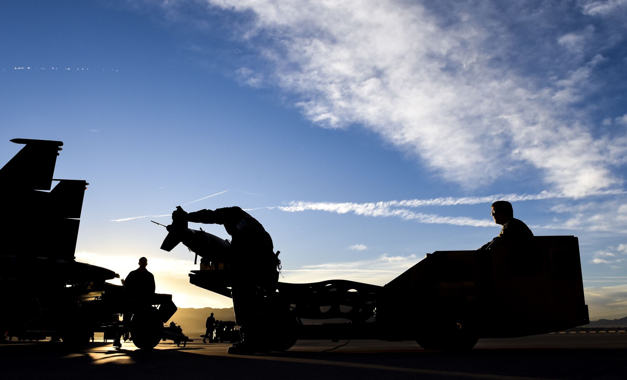 Airmen from the 57th Maintenance Group prepare to load a Mark 84 bomb onto an F-16 Fighting Falcon fighter jet for the quarterly load crew competition at Nellis Air Force Base, Nev., Jan. 5, 2018. Each Airman played a role to increase their team’s success by working as one cohesive unit. (U.S. Air Force photo by Airman 1st Class Andrew D. Sarver/Released)