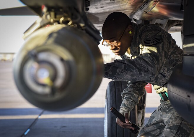 An Airman from the 57th Maintenance Group performs a final inspection on a Mark 84 bomb assembly during the quarterly load crew competition at Nellis Air Force Base, Nev., Jan. 5, 2018. A team’s accuracy, speed and focus on safety determined whether it would finish first or last in the competition. (U.S. Air Force photo by Airman 1st Class Andrew D. Sarver/Released)