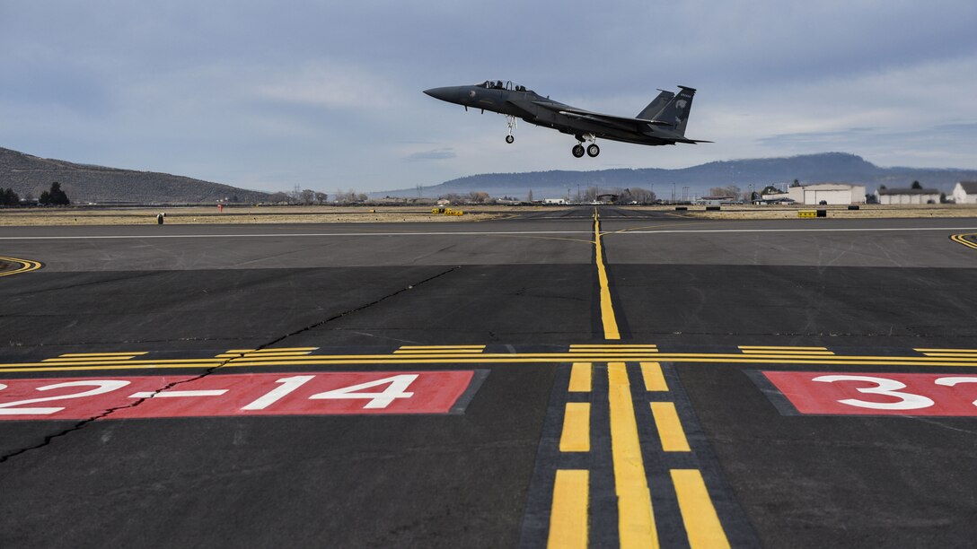 An aircraft takes off from a flight line.