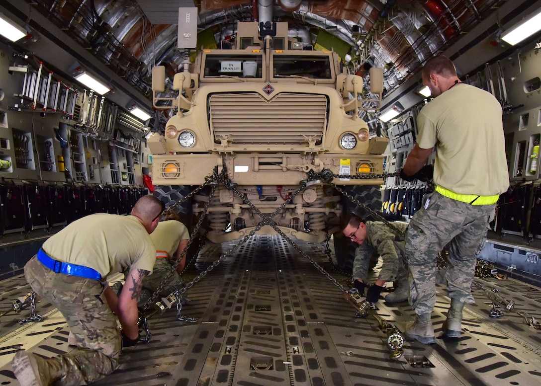 Ramp crew specialists from 386th Expeditionary Logistics Readiness Squadron secure MRAP onto C-17, December 28, 2017, before its transportation downrange at undisclosed location in Southwest Asia (U.S. Air Force/Louis Vega, Jr.)