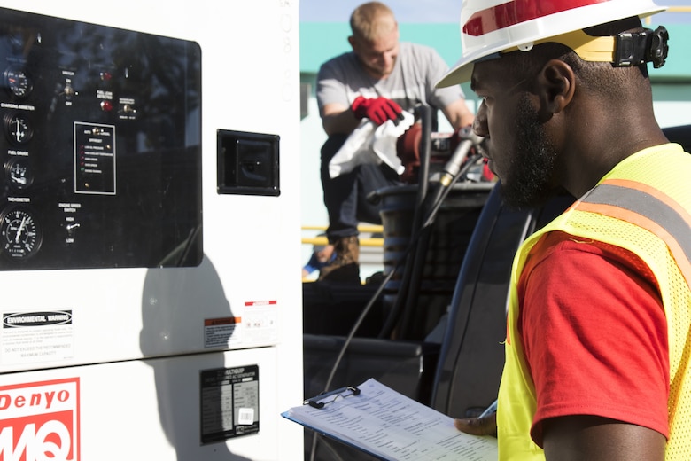 man inspects generator