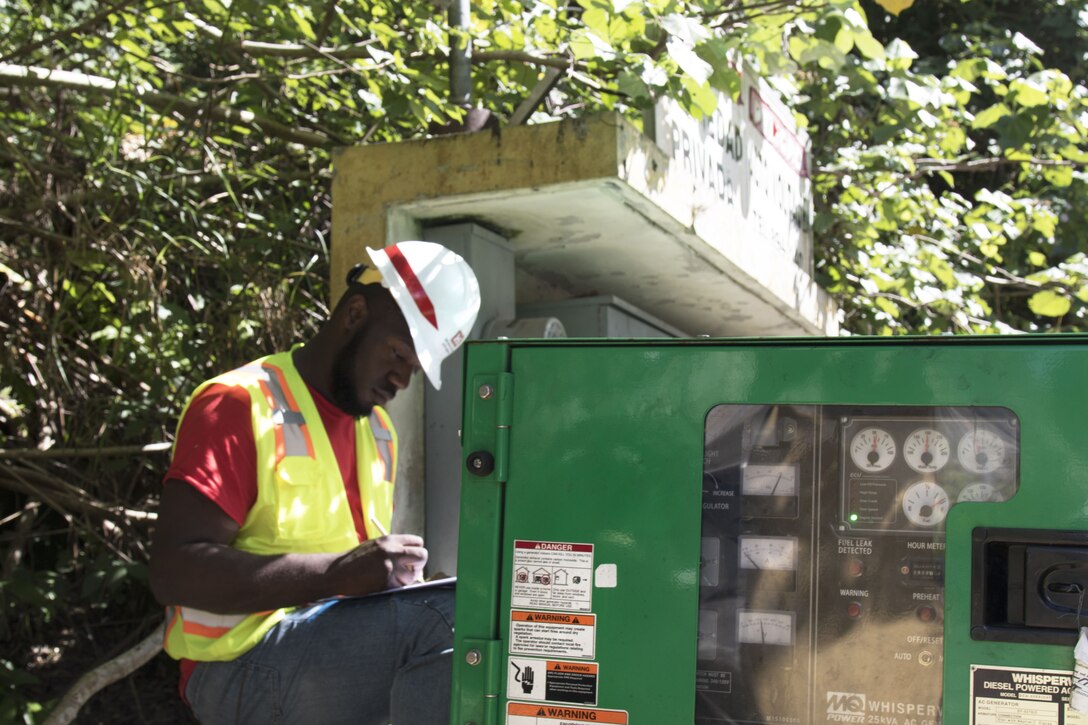 man works on generator