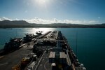 The amphibious assault ship USS America (LHA 6) pulls into Guam for a scheduled port visit. America, part of the America Amphibious Ready Group, with embarked 15th Marine Expeditionary Unit, is operating in the Indo-Asia-Pacific region to strengthen partnerships and serve as a ready-response force for any type of contingency.