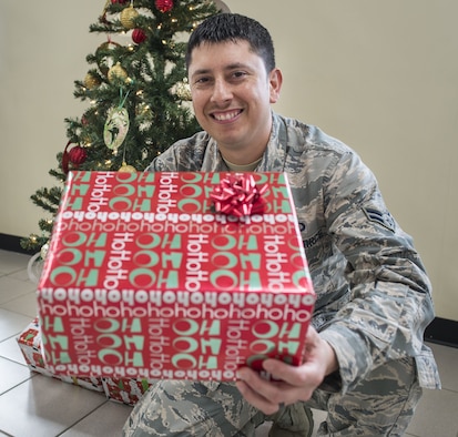 Airman 1st Class Guadalupe Salinas, 36th Operations Support Squadron weather forecaster, volunteered to be the liaison to ensure each child received a gift during the Merizo Angel Tree event, held Dec. 23, 2017, at Merizo Village, Guam. Airmen with the 36th OSS at Andersen Air Force Base, along with the U.S. Coast Guard Auxiliary, Station Apra Harbor, the Merizo Mayor's office and volunteers came together for the Merizo Angel Tree event to spread joy to community members. (U.S. Air Force photo by Airman 1st Class Christopher Quail)