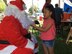 A local child grabs Santa Claus's beard during the Merizo Angel Tree event Dec. 23, 2017, at Merizo Village, Guam. Airmen with the 36th Operations Support Squadron at Andersen Air Force Base, along with the U.S. Coast Guard Auxiliary, Station Apra Harbor, the Merizo Mayor's office and volunteers came together for the Merizo Angel Tree event to spread joy to the less fortunate. (Courtesy photo by U.S. Air Force Lt. Col. Rafael Vargas)