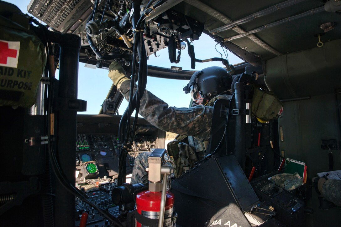 A National Guardsman prepare his helicopter for takeoff.