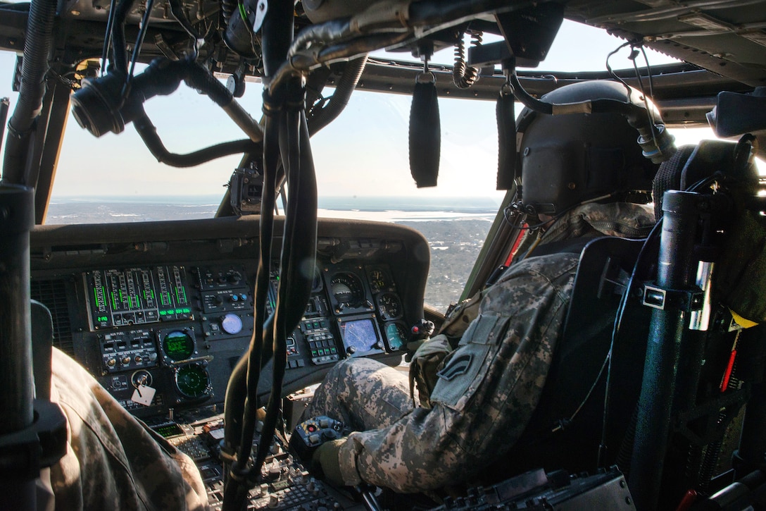 Guardsmen fly their UH-60 Black Hawk helicopter to pick up five civilian construction contractors.