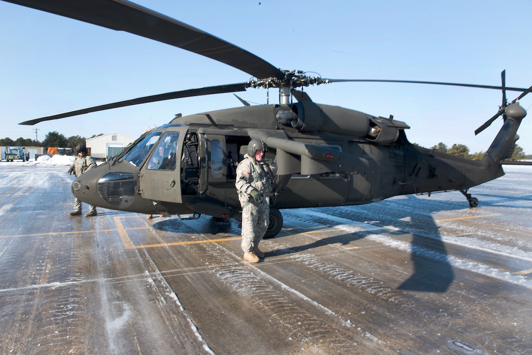 National Guardsmen prepare their UH-60 Black Hawk helicopter for flight.