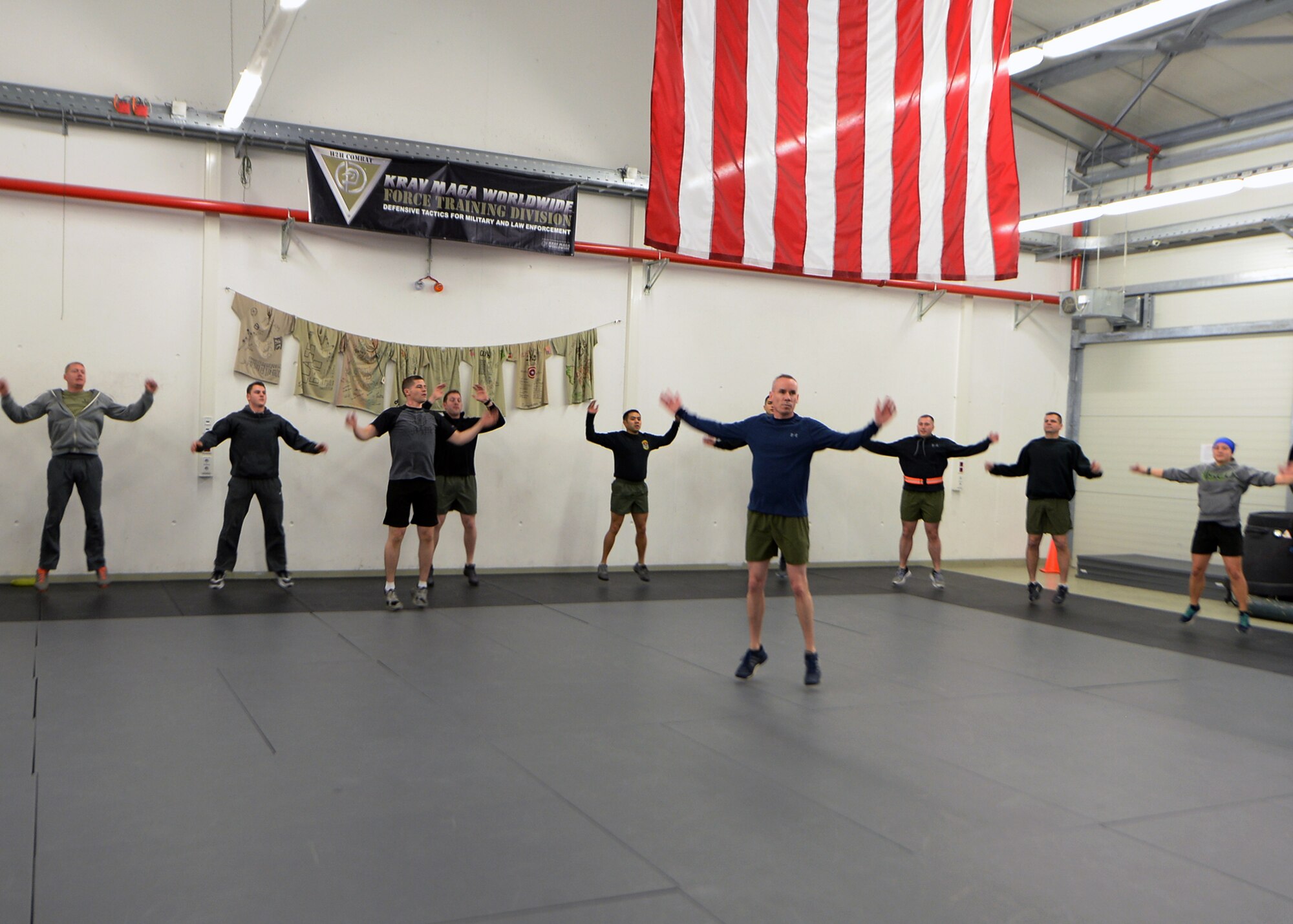 Airmen from multiple units participate in a warm-up at the 435th Security Forces Squadron gym on Ramstein Air Base, Germany, Jan. 5, 2018. Explosive Ordinance Disposal Airmen, Security Forces, and the 435th Air Ground Operations Wing leadership, came together to remember and honor fallen EOD service members. (U.S. Air Force photo by Senior Airman Jimmie D. Pike)