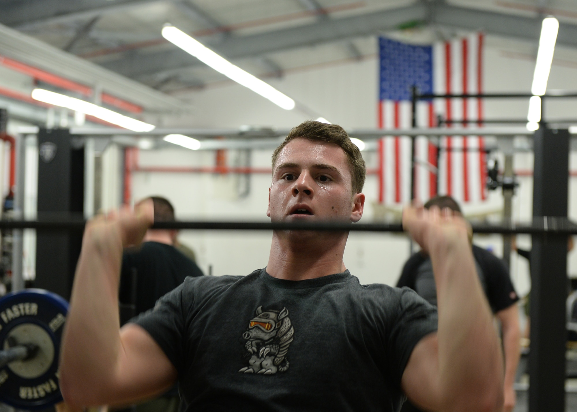 Senior Airman Logan Keller, 786th Civil Engineer Squadron explosive ordinance disposal technician, performs a push-press during an EOD Fallen Warrior Workout on Ramstein Air Base, Germany, Jan. 5, 2018. For the event, 12 teams of three Airmen competed to see who could finish the entire workout as a team the fastest. (U.S. Air Force photo by Senior Airman Jimmie D. Pike)