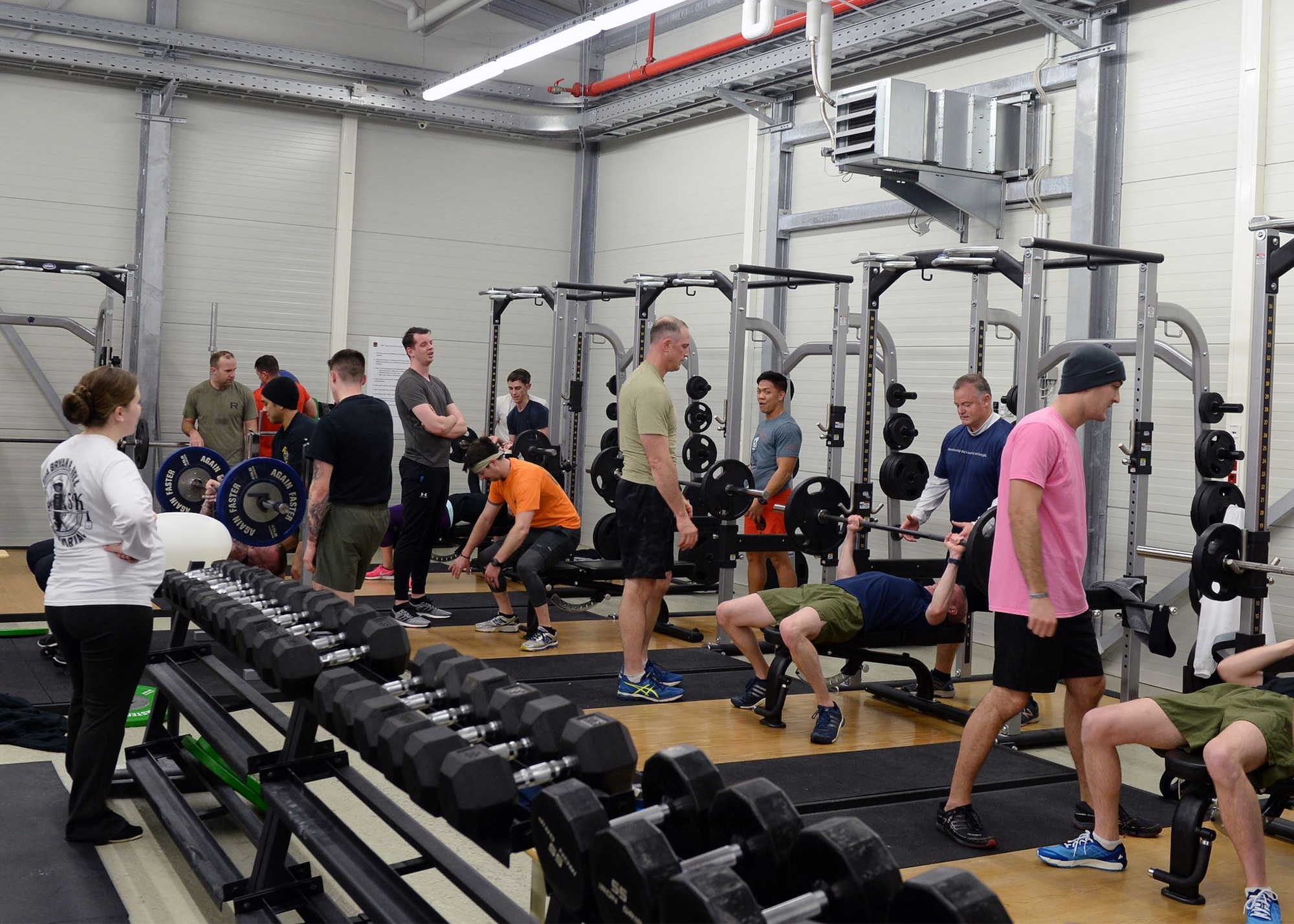 Airmen stationed at Ramstein Air Base, take part in a workout to remember and honor fallen explosive ordinance disposal Airmen who have lost their lives during service. For the workout, three-person teams were to complete a 1-mile run, 180 reps of bench-press, 180 reps of push-press, 180 reps of high-pull, and a final 1-mile run. A total of 36 Airmen from different units worked in teams to complete the workout the fastest. (U.S. Air Force photo by Senior Airman Jimmie D. Pike)