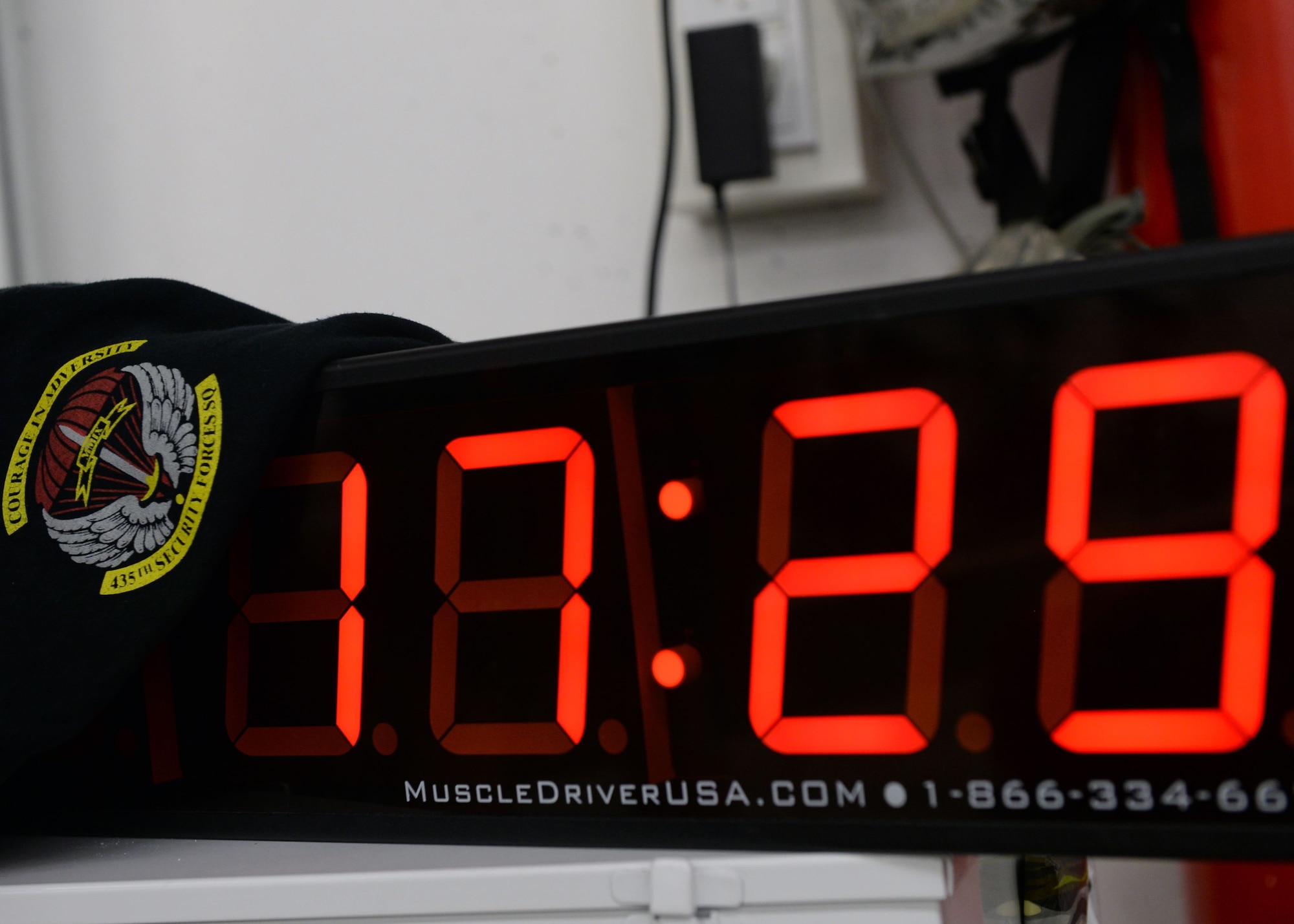 A clock tracks passing time as Airmen try to complete a full workout at Ramstein Air Base, Germany, Jan. 5, 2018. For the workout, three-person teams were to complete a 1-mile run, 180 reps of bench-press, 180 reps of push-press, 180 reps of high-pull, and a final 1-mile run. The fastest team completed the entire workout in under 35 minutes. (U.S. Air Force photo by Senior Airman Jimmie D. Pike)