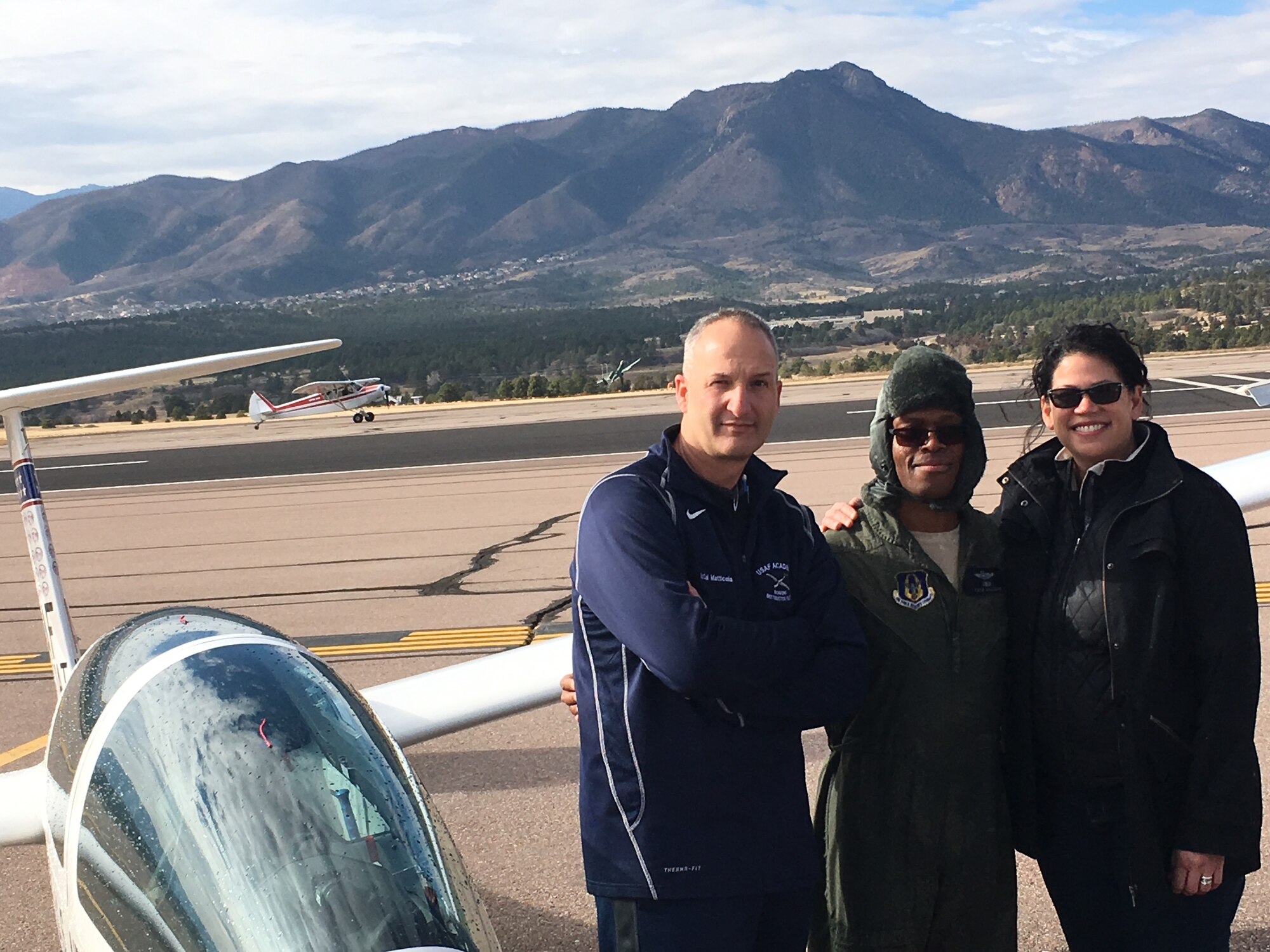 Lt. Col. Noel Williams (center) shares a moment following his final glider flight with wife Michelle and teammate Mark Matticola, U.S. Air Force Academy instructor pilot. Recently promoted to colonel, Williams will serve as a special assistant to the 340th Flying Training Group commander. (U.S. Air Force photo)
