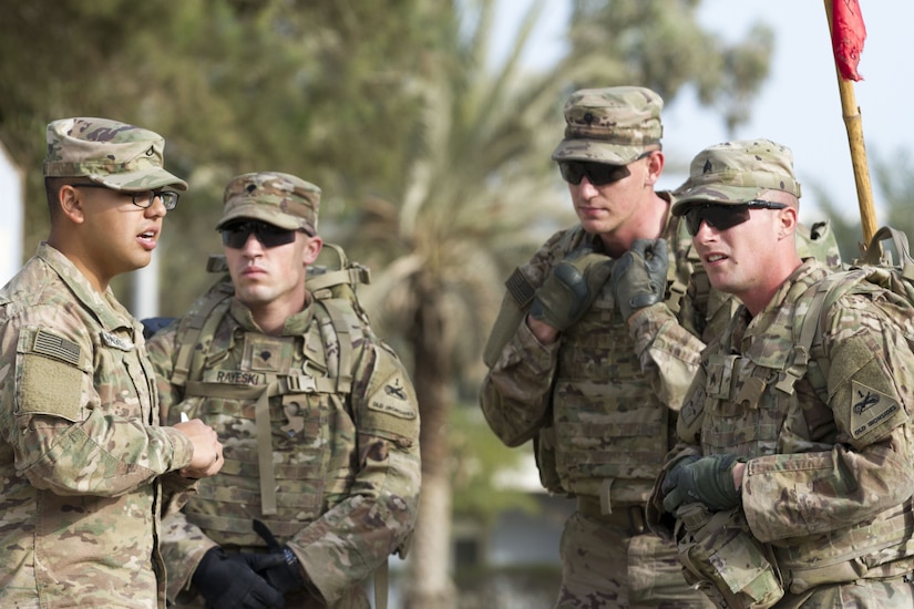 Four Soldiers standing in a group.