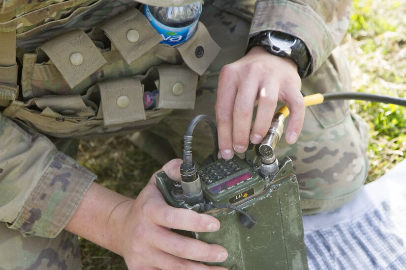 Soldier programs a radio.