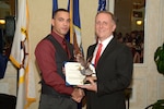 Petty Officer 1st Class Victor Ubri Jr. (left), a Navy officer recruiter assigned to Navy Recruiting District  San Antonio, stands with Commanding Officer Cmdr. Jeffrey Reynolds after being awarded NRD’s Active Officer Recruiter of the Year for Fiscal Year 2017 during the NRD’s annual award banquet held at the Crowne Plaza Hotel in Austin Dec. 19, 2017. Ubri became a recruiter to show people why America’s Navy is the good choice for military service. “This award means that I did my job to the best of my ability and was recognized for my efforts,” said Ubri. “I want to make sure the Navy’s future and our future Sailors are in capable hands.” Additionally, Ubri was awarded the Navy and Marine Corps Commendation Medal for his superior performance of duty.