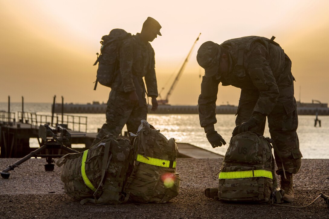 Soldiers prepare rucksacks before competing during the 2018 Iron Ram competition at Kuwait Naval Base, Kuwait.
