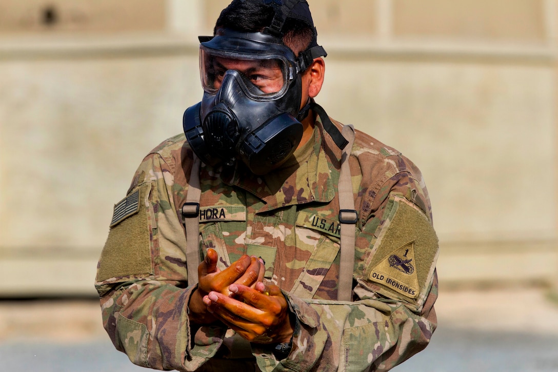 Army Pfc. Jesus Chora performs a decontamination procedure during the 2018 Iron Ram competition.