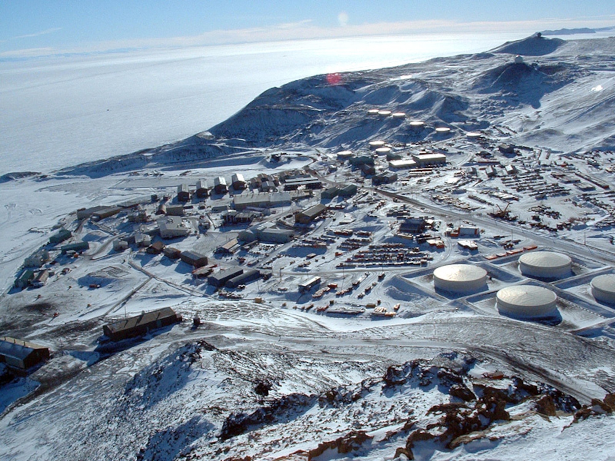 The National Science Foundation’s McMurdo Station, as seen from the summit of Observation Hill, Antarctica. The station was established in December 1955 and is the logistics hub of the U.S. Antarctic Program, with a harbor, landing strips on sea ice and shelf ice, and a helicopter pad. (Courtesy Photo)