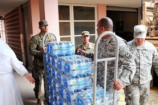Puerto Rico Army National Guardsmen assigned to the 92nd Maneuver Enhancement Brigade distribute needed articles, food and water after Hurricane Maria in San Juan, Puerto Rico, Dec. 29, 2017. Puerto Rico Army National photos by Spc. Hamiel Irizarry 